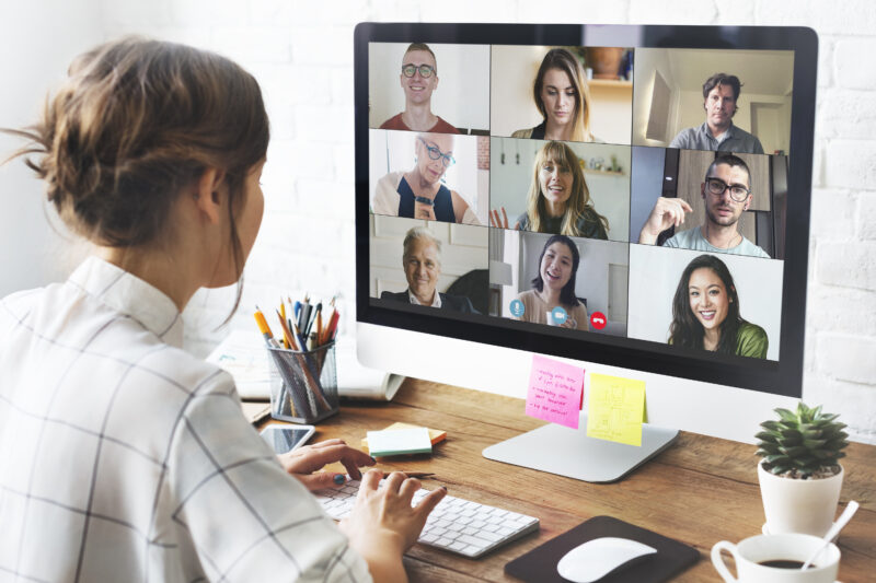 Woman in a video conference call in her home office talking with her collegues with teams